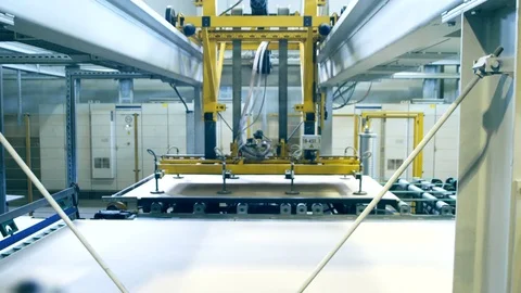 A manupulator is dragging sheets of plywood Stock Footage 74776565