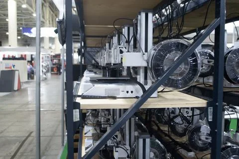 Many 3D printers printing an object. 3D printers simultaneously printing model Stock Photos