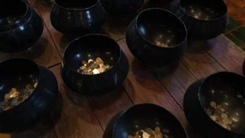 Many alms bowls displayed inside Thai temple Stockbeeldmateriaal 338268666