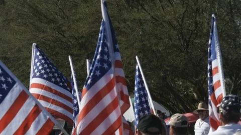 Many American flags being carried in a small town parade Stock Footage 119989672