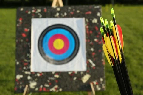 Many arrows against near target outdoors, closeup. Space for text Stock Photos