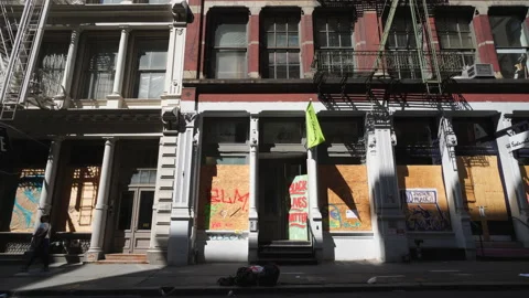 Many artists create mural on the barricade board of stores windows in SOHO Stock Footage 133372888