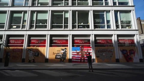 Many artists create mural on the barricade board of stores windows in SOHO Video stock 133377855