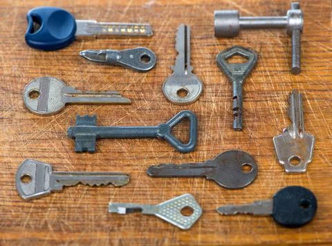 Many assorted old multi-colored metal antique vintage keys of different shape Stock Photos
