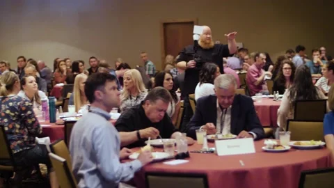 Many attendees sitting at tables Video stock 137348236