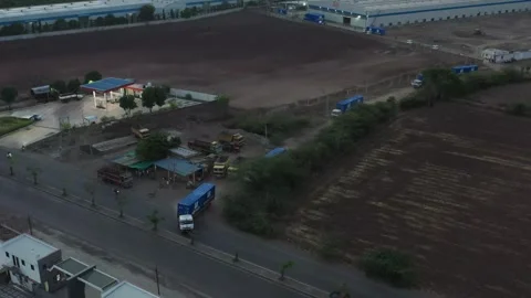 Many auto trucks with shipping containers going through warehouse, aerial view Stock Footage 303046545