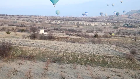 Many balloons flying over the valleys in Goreme, Turkey. Stock Footage 157690115