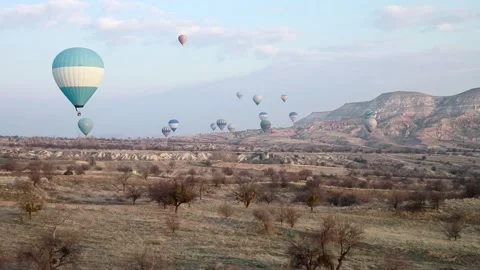 Many balloons flying over the valleys in Goreme, Turkey. Stock Footage 157690140