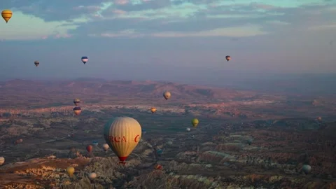 Many balloons flying over the valleys in Goreme, Turkey. Stock Footage 157690144