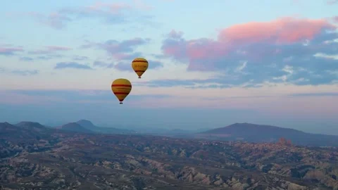 Many balloons flying over the valleys in Goreme, Turkey. Video stock 157690340