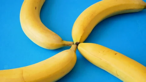 Many bananas dance on blue background. stop motion animation, time lapse, Stock Footage 141798809