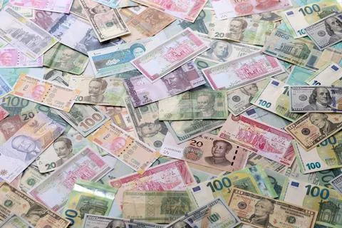 Many banknotes of different currency. Background of big amount of random money Stock Photos