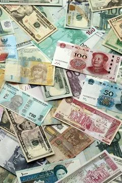 Many banknotes of different currency. Background of big amount of random money Stock Photos