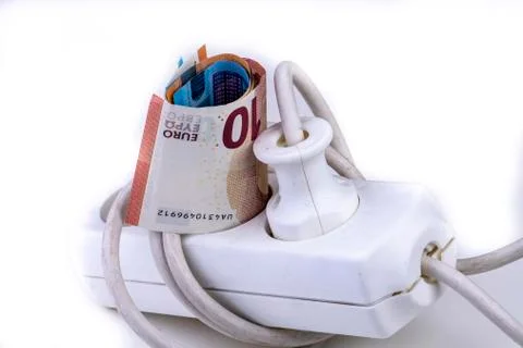 Many banknotes in a multiple socket expensive electricity prices Stock Photos