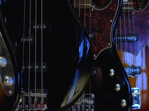 Many bass guitars on the wall Video stock 73836766