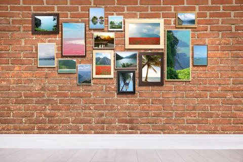 Many beautiful landscapes in frames on brick wall in room Stock Photos