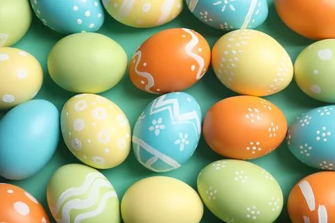 Many beautiful painted Easter eggs as background, top view Stock Photos