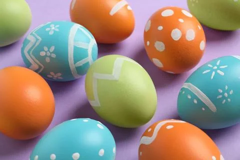 Many beautiful painted Easter eggs on color background, closeup Stock Photos