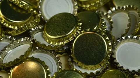 Many beer cap spin on table Stock Footage 120685918
