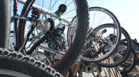 Many bicycles, wheels, cyclists preparing to ride around the city sunny day Stock Footage 61805793