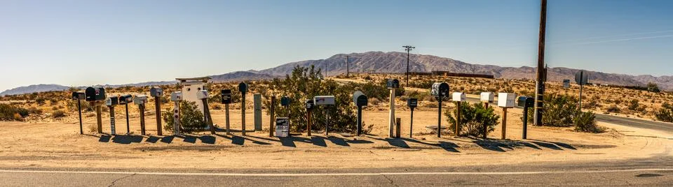 Many of black and white mailbox in row standing by crossroads in american d.. Stock Photos