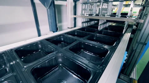 Many black plastic containers moving along the conveyor Video stock 150195961