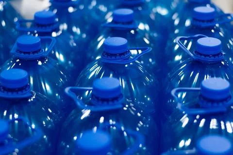 Many blue chemical liquid plastic bottles. Group of bottles close up Stock Photos