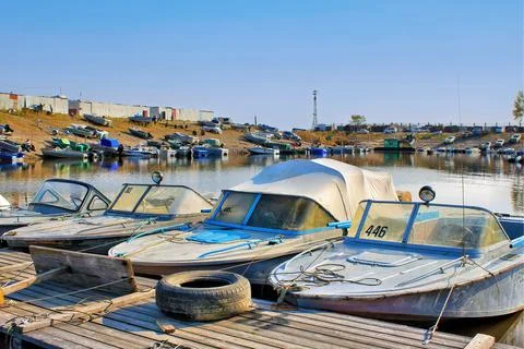 Many boats and launchs are moored at the boat station Stock Photos
