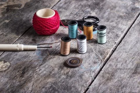 Many bobbin of thread with needle and button Foto stock