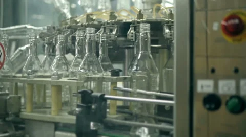 Many bottles of vodka or gin on conveyor belt in factory. Bottling plant Stock Footage 65101605