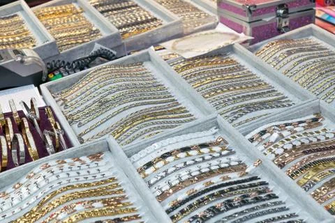 Many bracelets are in the boxes on the table. Stock Photos