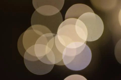 Many bright blurry circles overlapping against dark background 写真素材