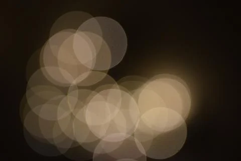 Many bright blurry circles overlapping against dark background 写真素材