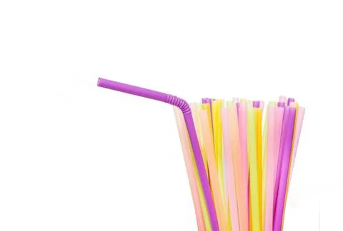 Many bright multi-colored plastic tubes for beverages on a white background. Stock Photos