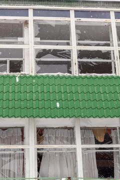 Many broken windows on the brick wall of the building after the explosion Stock Photos