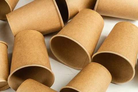 Many brown disposable empty paper cups. Stock Photos
