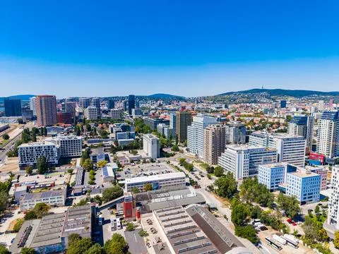 Many buildings and structures fill the area with cars on the streets. There a Stock Photos
