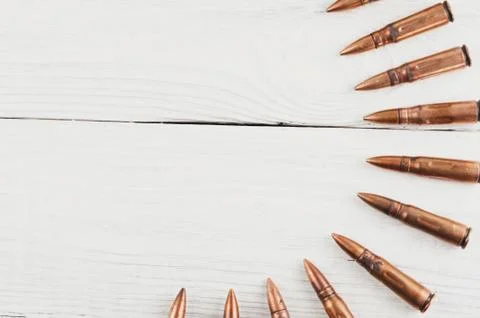 Many bullets for assault rifle on rustic white wooden planks Stock Photos