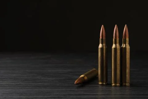 Many bullets on black wooden table. Space for text Stock Photos