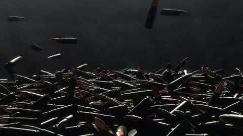 Many bullets fall on the table. In the background a dark wall Foto stock