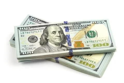 Many bundle of US 100 dollars banknotes isolated on a white background. Close up Stock Photos