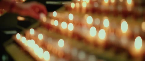 Many burning candles with blurred glowing background in the darkness. Stock Footage 252836728