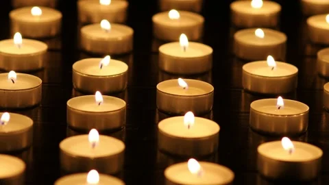 Many burning candles with shallow depth of field. Candles flicker in the dark Stock Footage 224105710