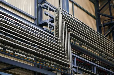 Many cable trays installed on the wall of the building. Internal plant Stock Photos