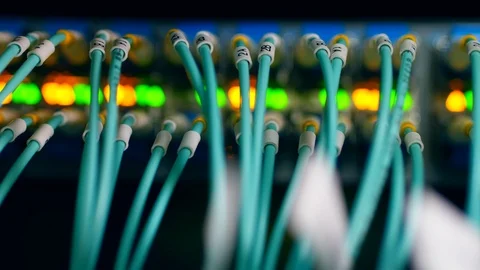 Many cables plugged to one computer in a server room. 스톡 동영상 111577648