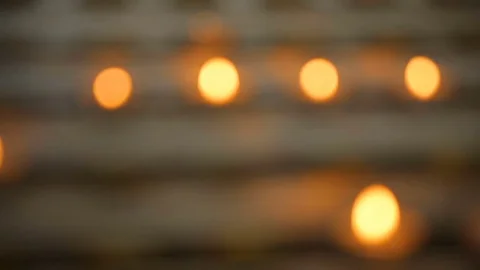 Many candle flames glowing in the dark, create a spiritual atmosphere Stock Footage 80709397