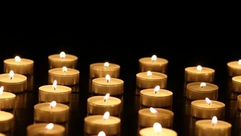 Many candle flames glowing on dark background. Stock Footage 224105830