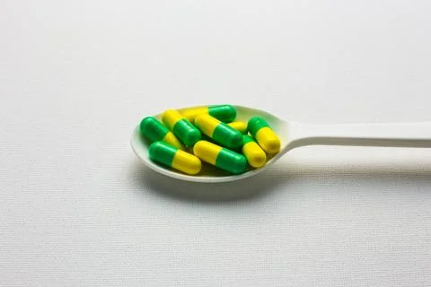 Many capsules pills on a spoon Stock Photos