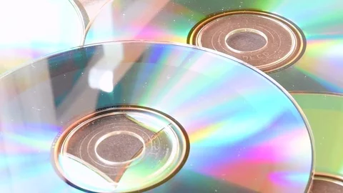 Many cd with reflections on a table, one more it’s put on them Stock-Footage 79853605