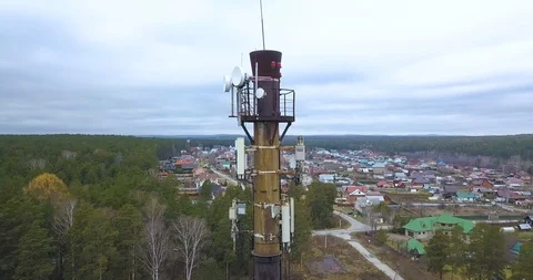 Many cellular antennas on the pipe. Flying around the tube quadcopter Stock Footage 119522890